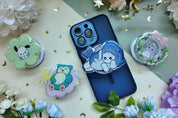 Phone case with cartoon character and pop sockets on a floral background